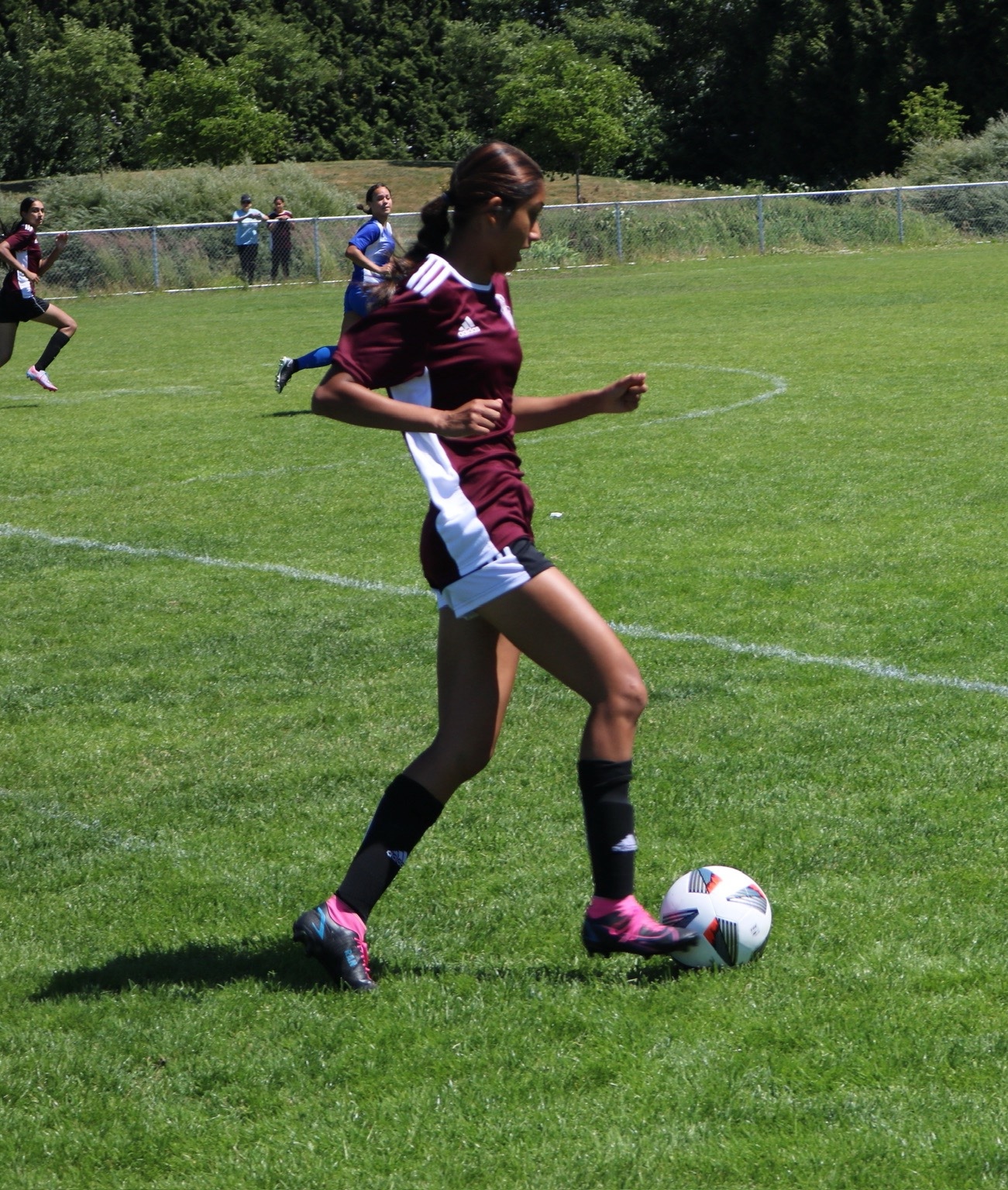 Girl running with a soccer ball